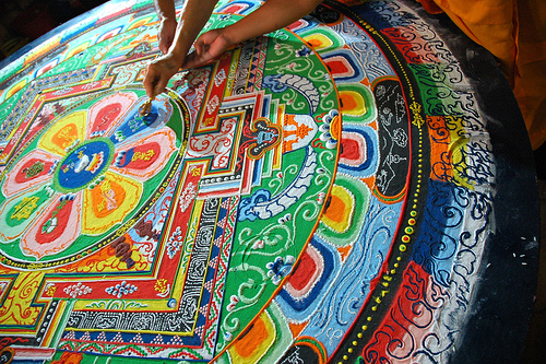 His Holiness Dagchen Rinpoche´s hand holds a vajra drawing lines that close the Hevajra Mandala, after the empowerment / initiation, Tharlam Monastery, Boudha, Kathmandu, Nepal